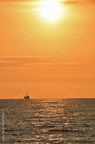 Golden Sunset at the Beach with Boat © LaDonna