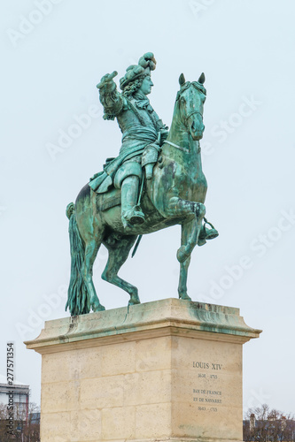 Equestrian statue of Louis XIV on Place d'Armes in front of Palace of Versailles. Palace Versailles was a royal chateau. photo