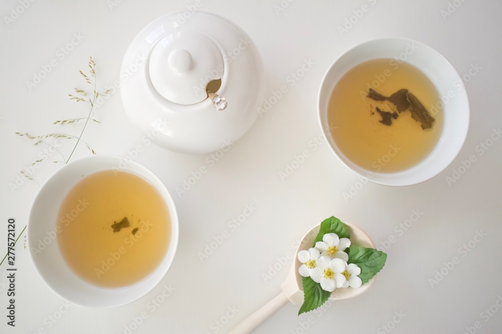 set with green tea, cups and kettle, mint leaves and chamomile flowers, with free space for text, long wide banner set with green tea, cups and kettle, mint leaves and chamomile flowers, with free space for text, long wide banner