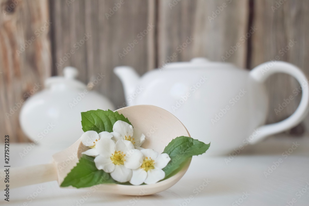 set with green tea, cups and kettle, mint leaves and chamomile flowers, with free space for text, long wide banner