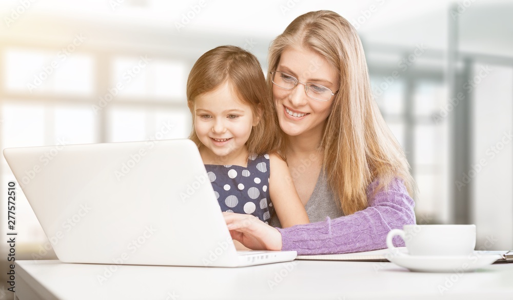 Happy mother with dauther using laptop at home Happy mother with dauther using laptop at home