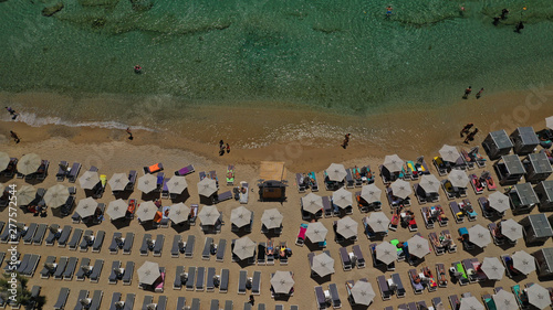 Aerial drone photo of famous organised with sun beds and umbrellas beach of  Paradise with emerald clear sandy sea shore, Mykonos island, Cyclades, Greece   photo