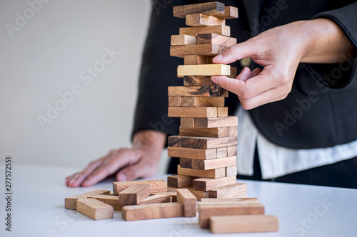 Alternative Risk and Strategy in Business, Hand of intelligent business woman gambling placing making wooden block hierarchy on the tower to planning and development to successful