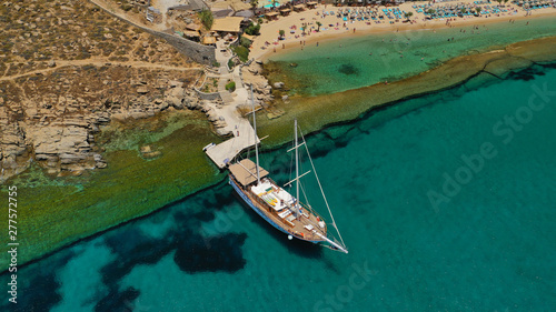 Aerial drone photo of famous organised with sun beds and umbrellas beach of  Paradise with emerald clear sandy sea shore, Mykonos island, Cyclades, Greece   photo