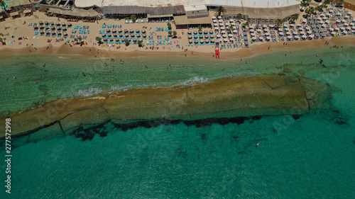 Aerial drone photo of famous organised with sun beds and umbrellas beach of  Paradise with emerald clear sandy sea shore, Mykonos island, Cyclades, Greece   photo