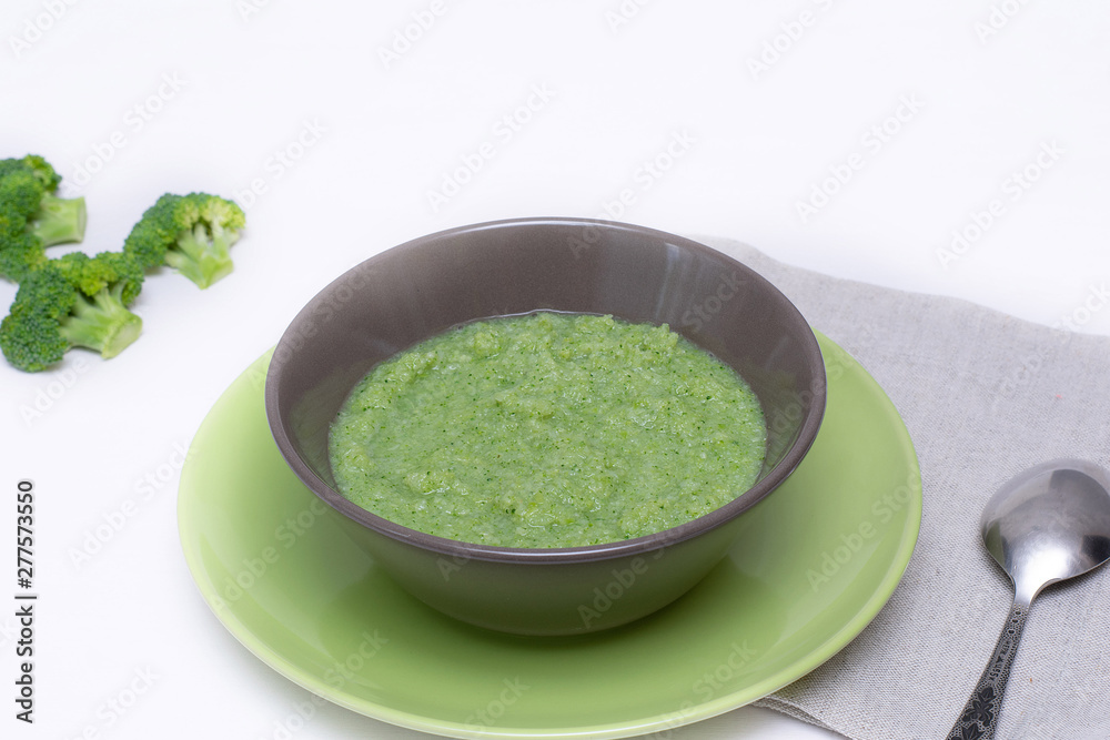 Vegetarian soup of broccoli puree on a white background. The concept of healthy eating.