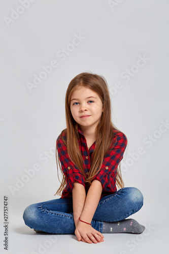 Teenage girl with emotional facial expression. Beautiful female half-length portrait isolated on lithg background.