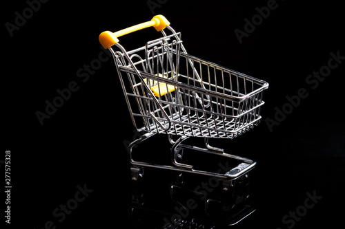Close-up of shopping carts on black background.Trolley, Sale concept.Empty grocery shopping cart. Isolated over black background.