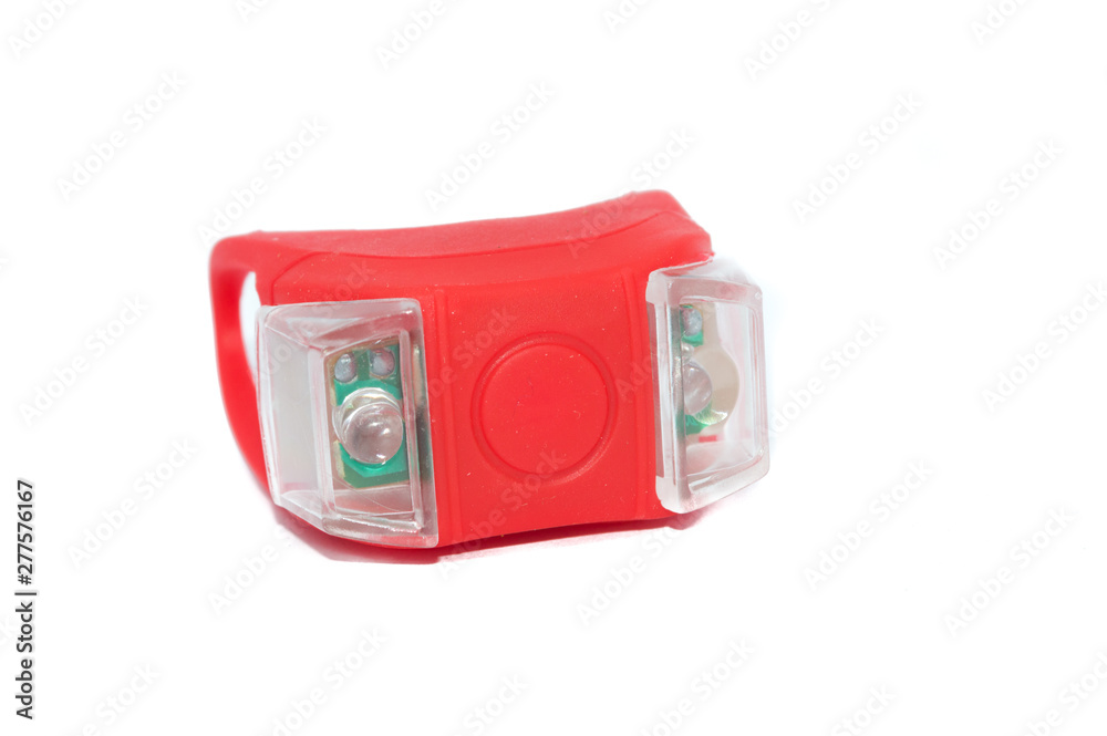 Obraz premium red bike light for night pedal safety isolated on white background