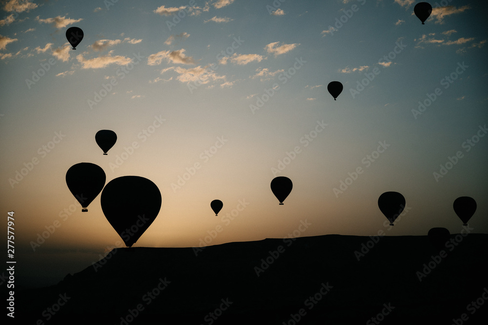 Obraz premium Hot air balloons landing in a mountain Cappadocia Goreme National Park Turkey.