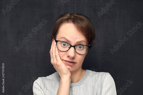 Portrait of upset girl with eyeglasses