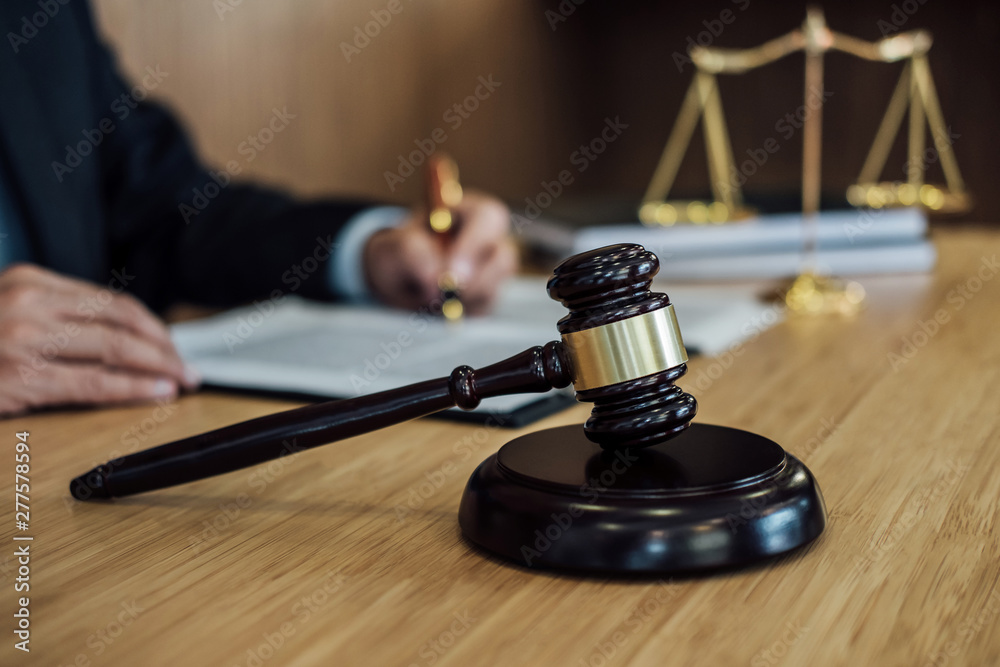 Judge gavel with Justice lawyers, Businessman in suit or lawyer working on a documents. Legal law, advice and justice concept Judge gavel with Justice lawyers, Businessman in suit or lawyer working on a documents. Legal law, advice and justice concept