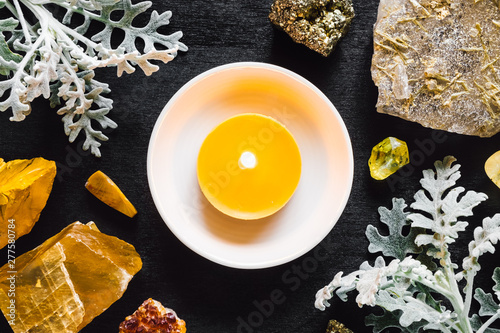 Yellow Candle with Stones of the Solar Plexus Chakra photo