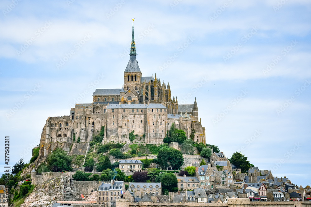 Close-up of Mont Saint Michel, France, in a blue cloudy sky.