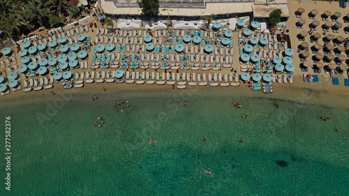 Aerial panoramic photo of famous turquoise clear sea celebrity sandy beach and bay of Psarou with yachts and sail boats in iconic island of Mykonos, Cyclades, Greece