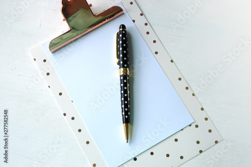 Mock Up Clipboard and Black White Polka Dot Pen on White Table... photo