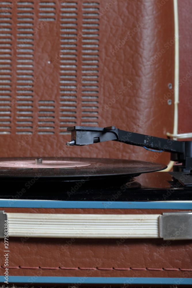 An old gramophone with a vinyl record mounted on it.