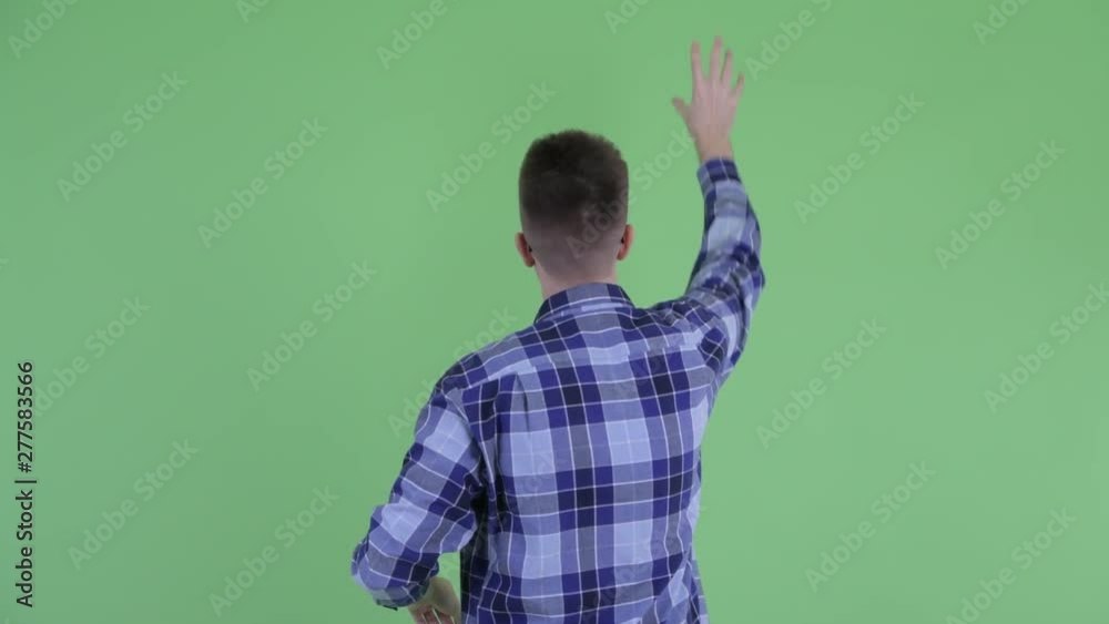 Rear view of young hipster man touching something Rear view of young hipster man touching something
