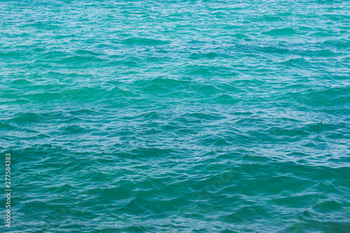 simple natural background picture of slightly wavy blue water surface 