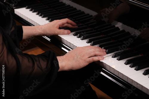 Close-up of a music performer's hand playing the piano