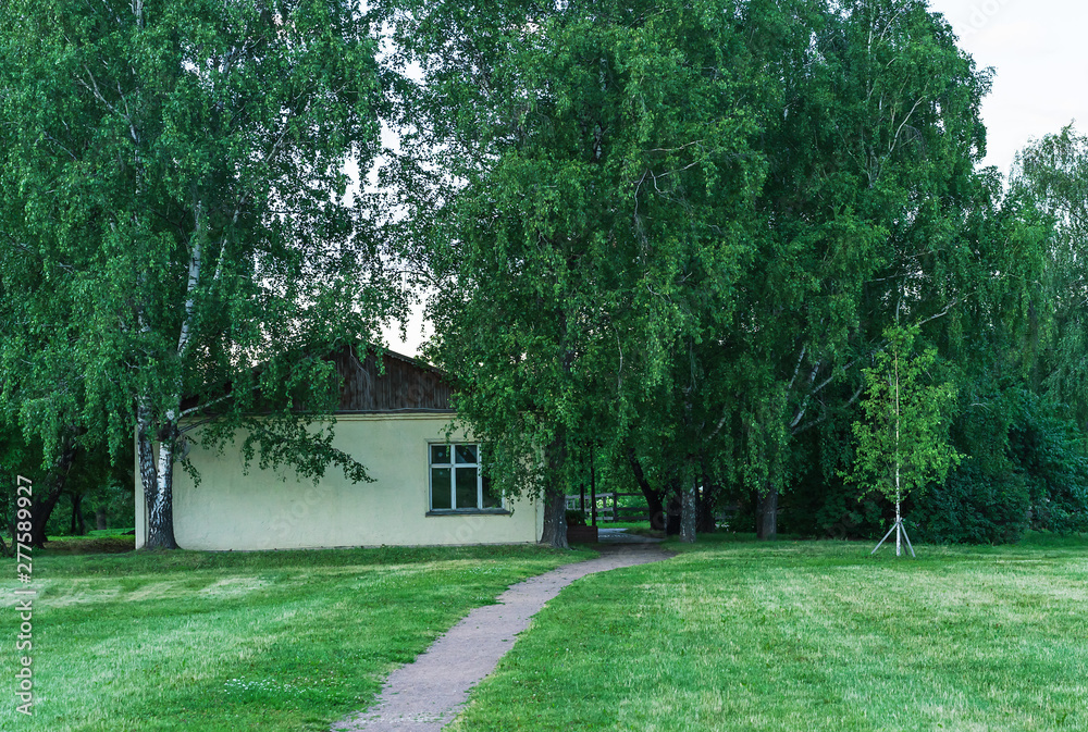 House and footpath in the village. Rural landscape with an old house and footpath. House and footpath in the village. Rural landscape with an old house and footpath.