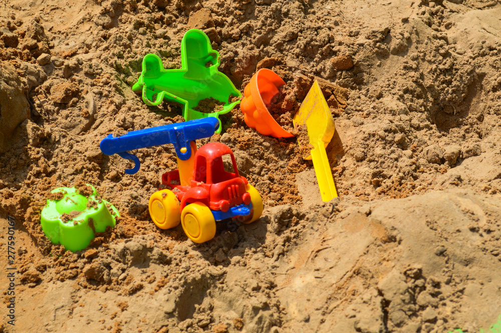 Children's sandbox on the playground for games with toys for children by truck, car, excavator, sand dressers with a spatula Children's sandbox on the playground for games with toys for children by truck, car, excavator, sand dressers with a spatula