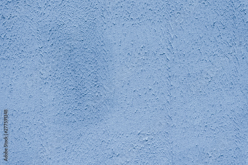The brightly painted surface is covered with smoky dusty blue plaster. Background for copy space