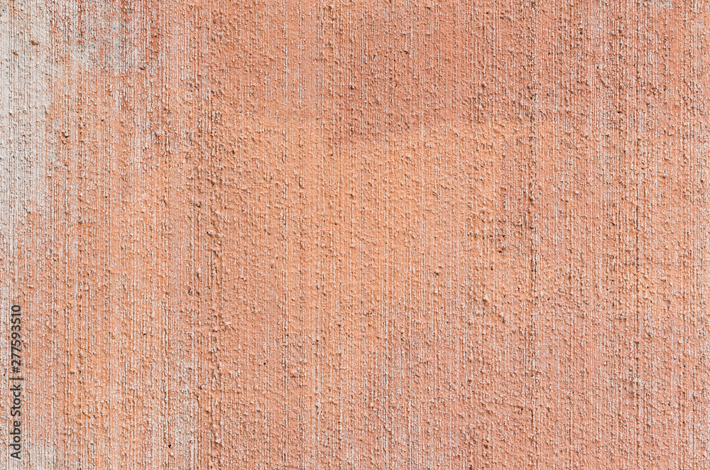 Fototapeta premium Close-up of plastered, painted, weathered, rough and red, orange or peachy concrete or stone wall. High resolution full frame textured background.
