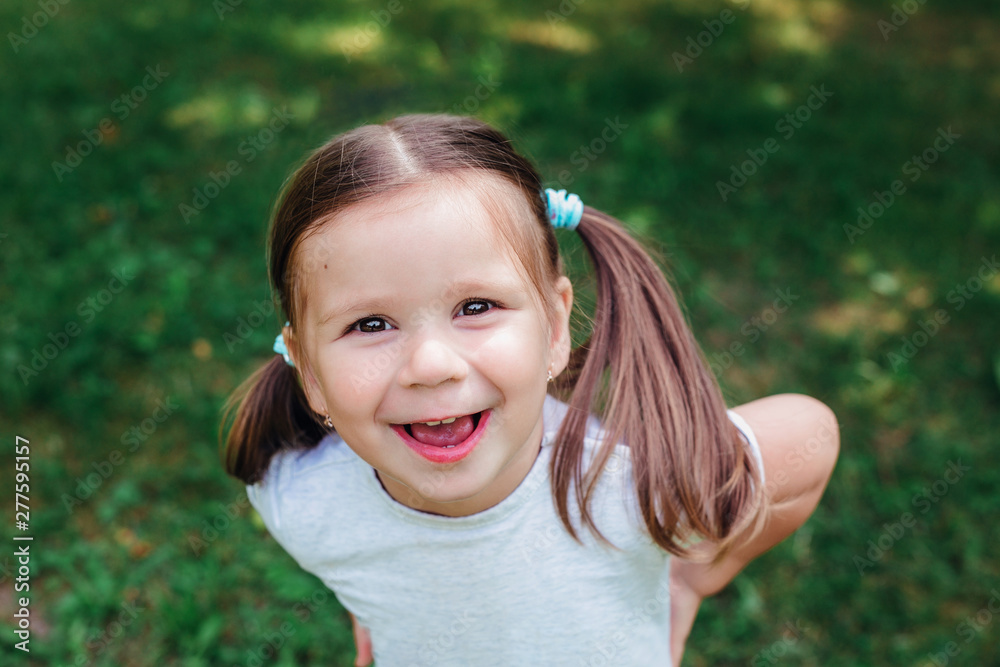Portrait of funny beautiful little girl in the summer Portrait of funny beautiful little girl in the summer
