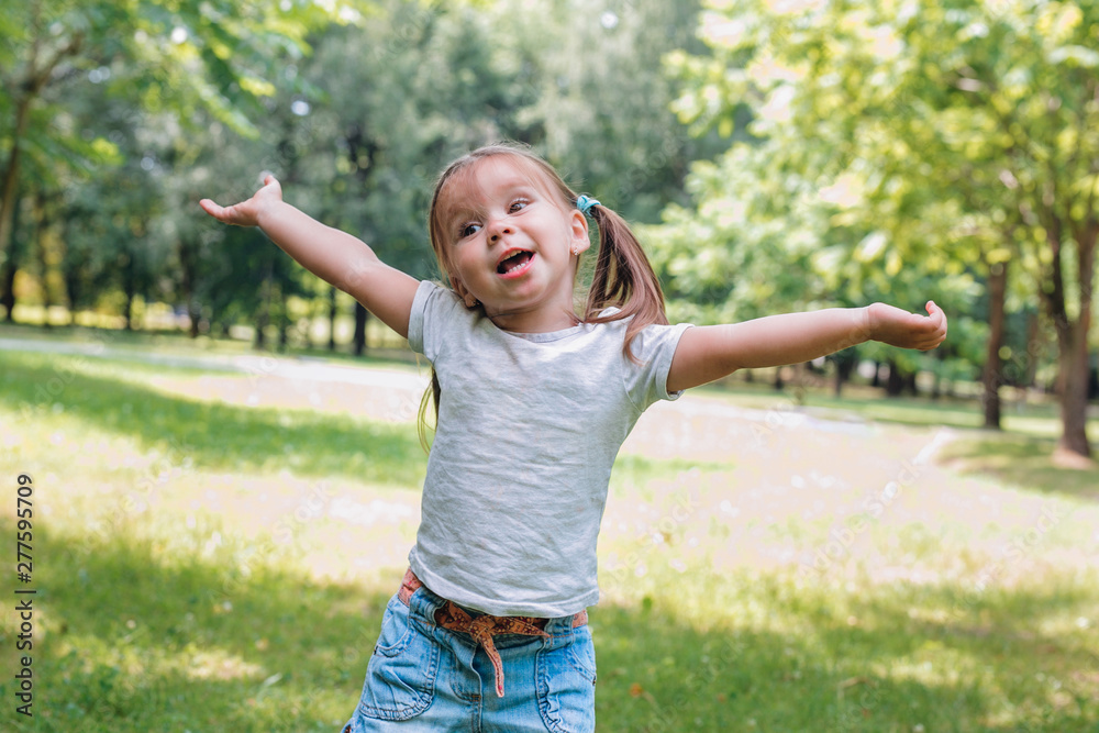Happy little child in summer park. Happiness and freedom Happy little child in summer park. Happiness and freedom