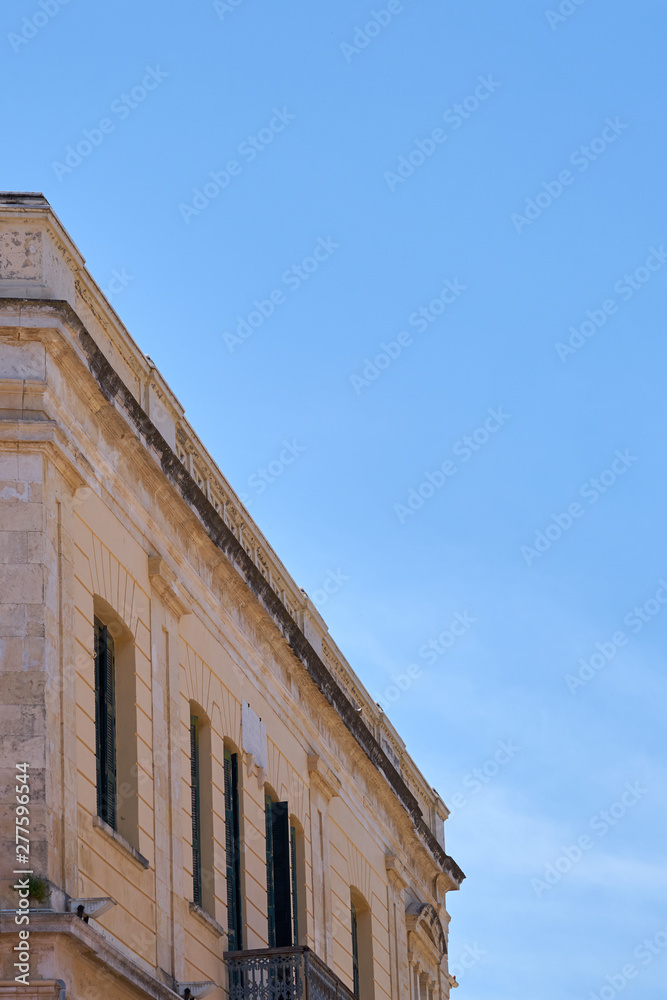 A facade of an old building in Chania, Crete, Greece against a clear blue sky. Copy space.