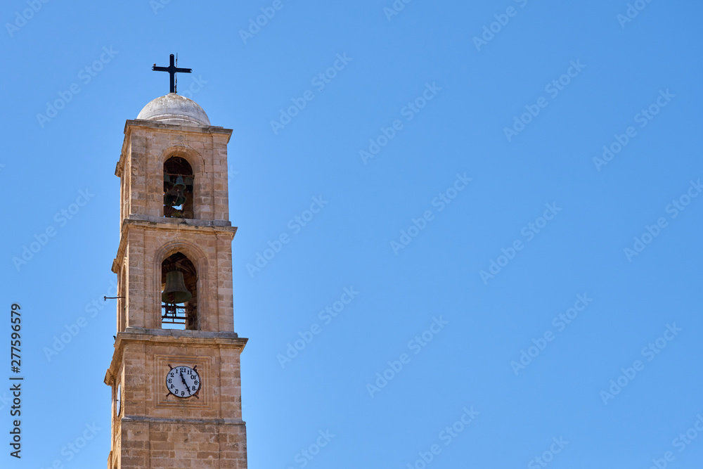 Clocktower of a church against a clear blue sky in Chania, Crete, Greece. Copy space.