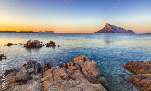 Fototapeta Naklejka Na Ścianę i Meble -  Fantastic azure water with rocks near beach Porto Taverna at sunset