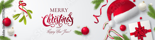 Vector horizontal banner with text Merry Christmas, Santa Claus hat, gift box, red ribbons, toys, candy canes, mistletoe and branches of fir tree. Festive Xmas background for website header or flyer.