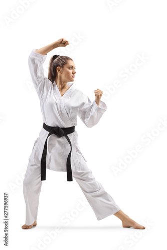Konstfotografi Woman with black belt and kimono practicing karate kata