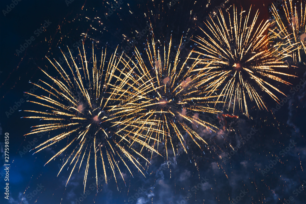Inexpensive yellow fireworks over blue sky with colour sparks. Selective focus. Bright and shiny. Celebration concept. Inexpensive yellow fireworks over blue sky with colour sparks. Selective focus. Bright and shiny. Celebration concept.