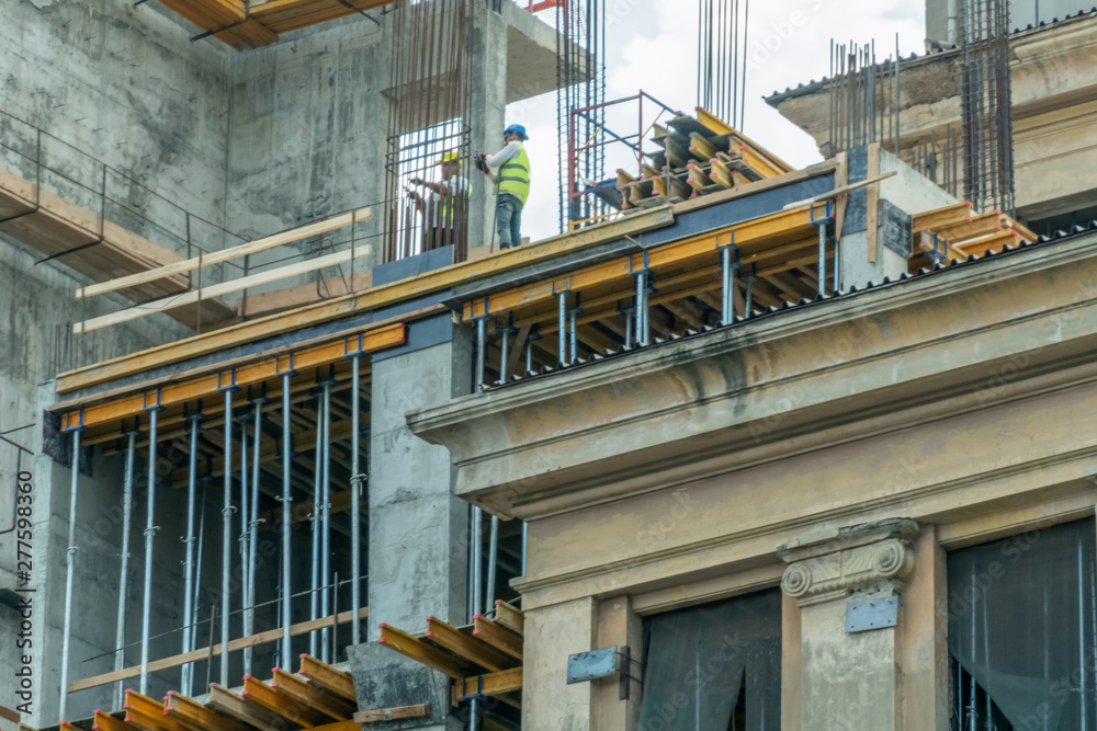 Fototapeta premium Builders install piles on the house. Home construction. Construction concept