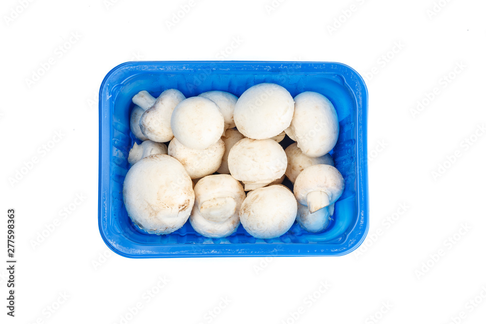Mushrooms in a plastic blue container isolated on white, top view Mushrooms in a plastic blue container isolated on white, top view