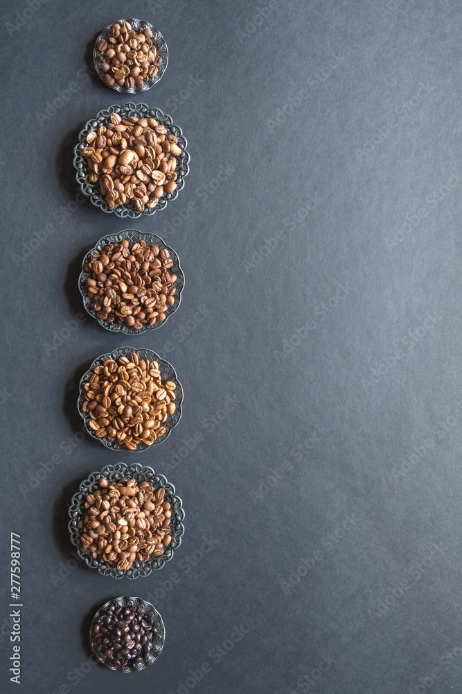 Varieties of roasted coffee beans on a black table