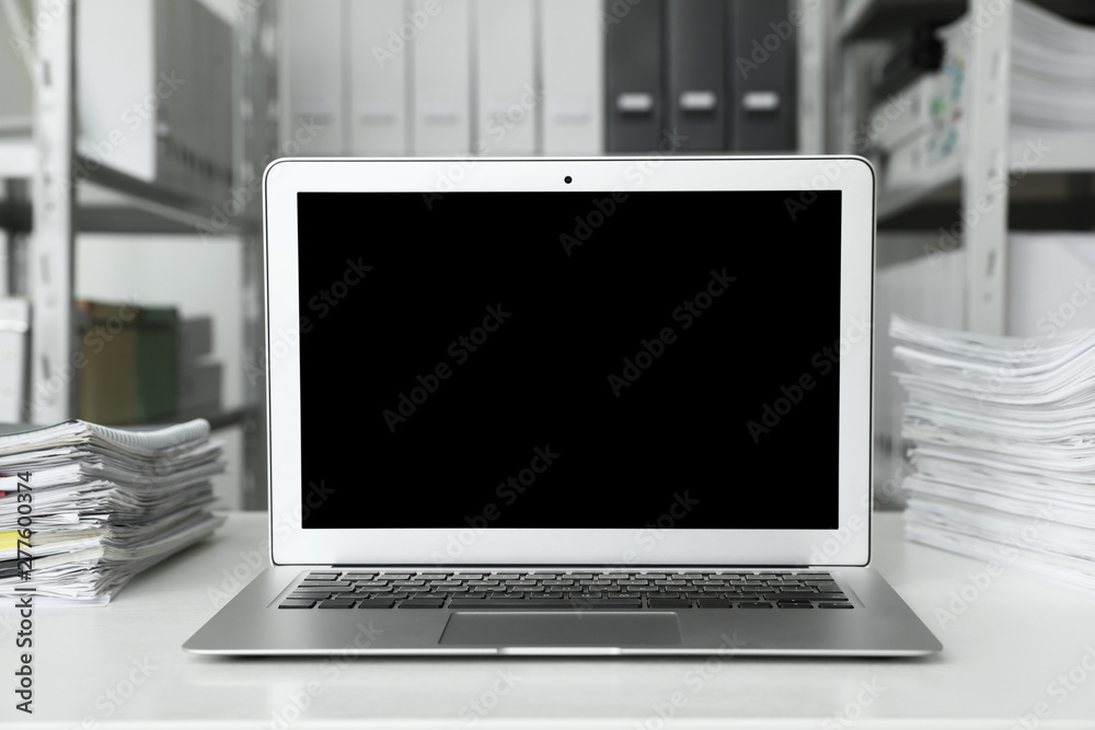 Fototapeta premium Laptop and documents on desk in office. Space for text