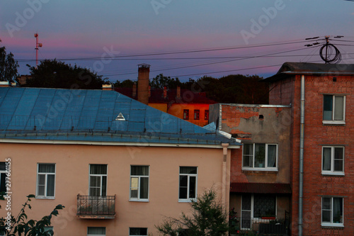 evening windows of residential buildings in a residential area of the city at sunset © Sergey