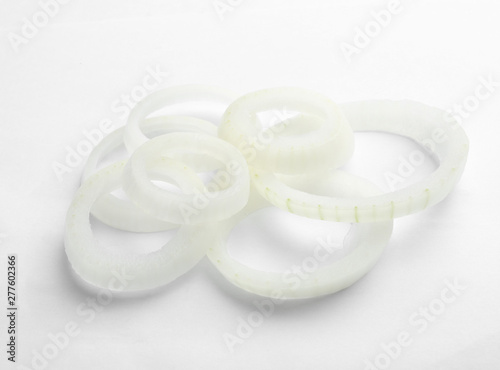 Fresh raw onion rings on white background