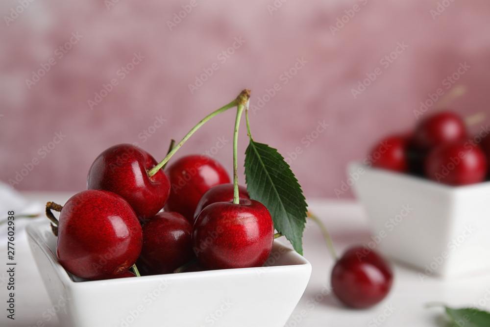 Bowl with ripe sweet cherries on table, closeup. Space for text Bowl with ripe sweet cherries on table, closeup. Space for text
