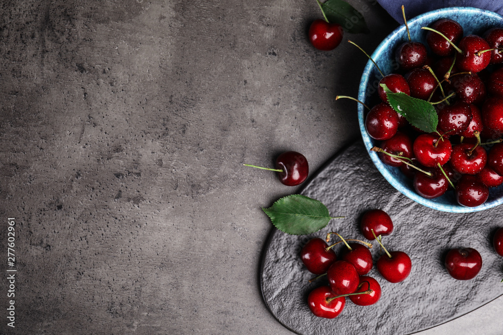 Flat lay composition with sweet cherries on grey table. Space for text Flat lay composition with sweet cherries on grey table. Space for text