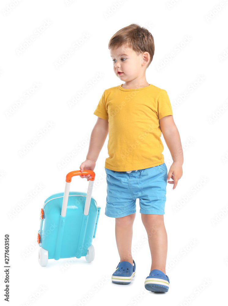 Cute little boy walking with blue suitcase on white background Cute little boy walking with blue suitcase on white background