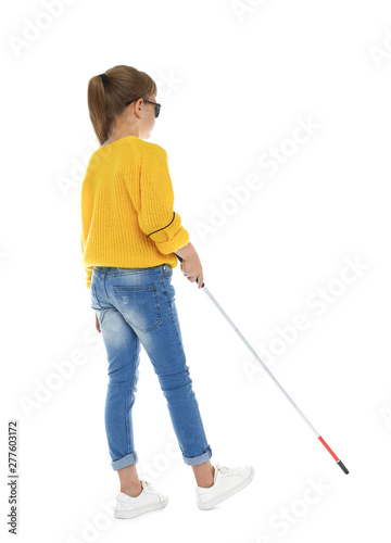 Blind girl with long cane walking on white background