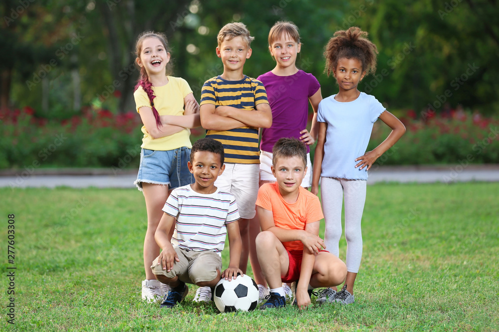 Cute little children with soccer ball in park. Outdoor play Cute little children with soccer ball in park. Outdoor play