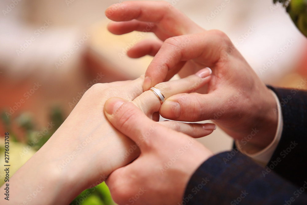 Cropped view at a man's hand putting ring on a woman hand Cropped view at a man's hand putting ring on a woman hand