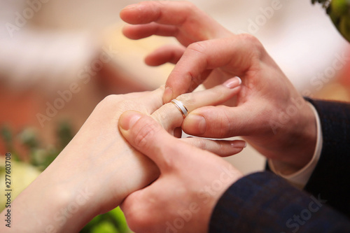 Cropped view at a man's hand putting ring on a woman hand