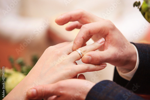 Cropped view at a man's hand putting ring on a woman hand